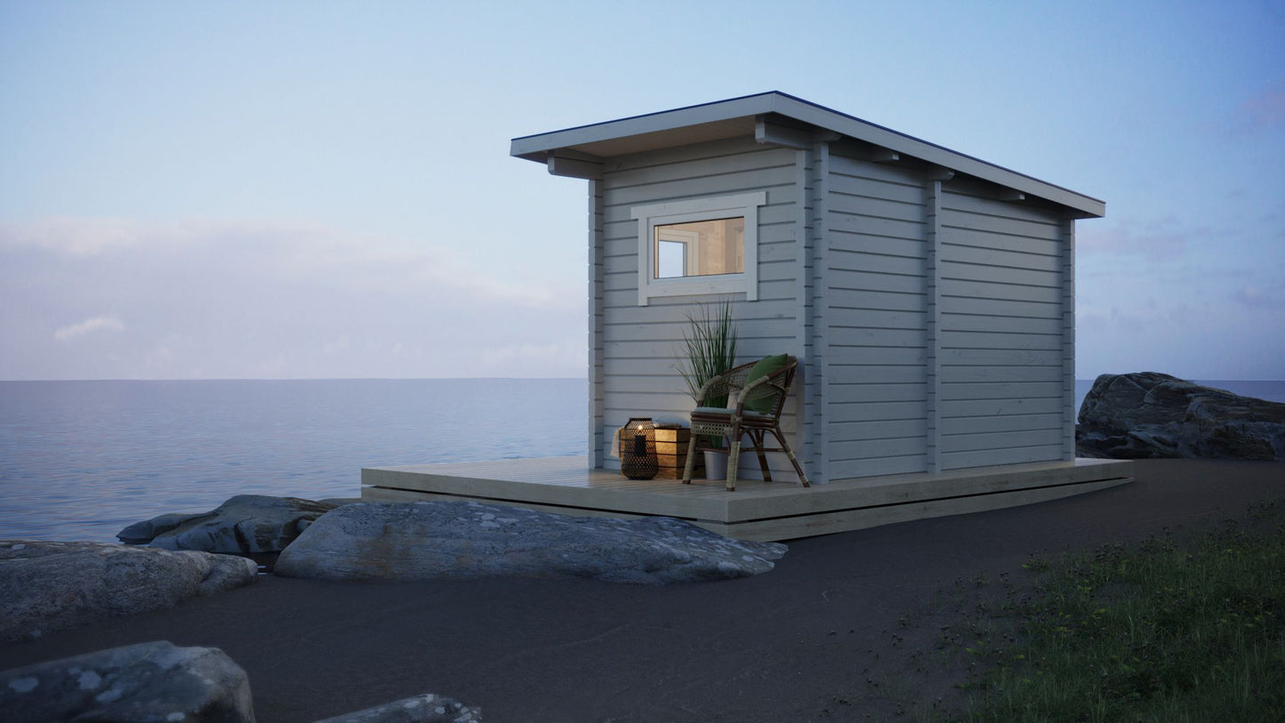 Saunamo Sauna extérieur Nordica sur la plage avec chaise et plantes.